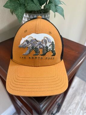 The North Face Mustard Yellow and Black Trucker Hat with Embroidered Bear